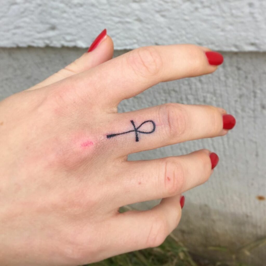 Ankh tattoo on the finger for women