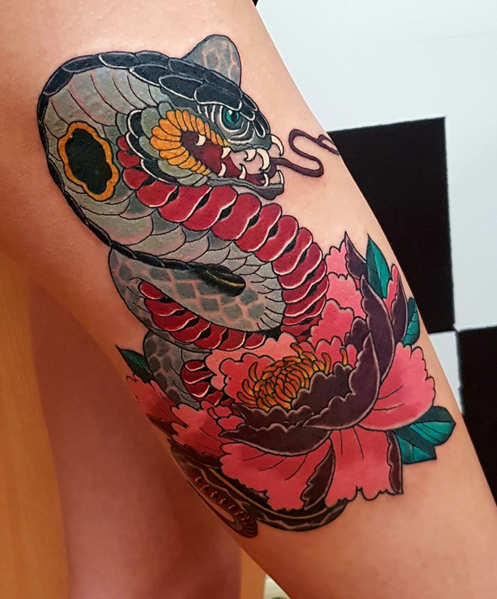 Colorful new-school style cobra tattoo on the thigh for women