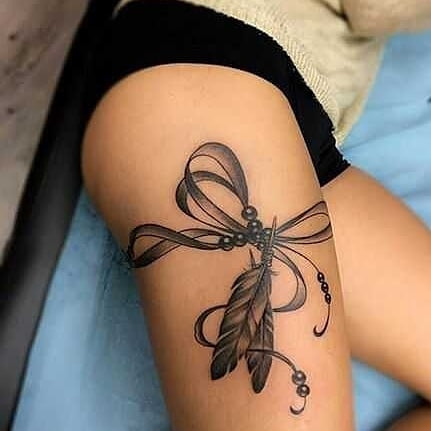 Bow tattoo on thigh for women