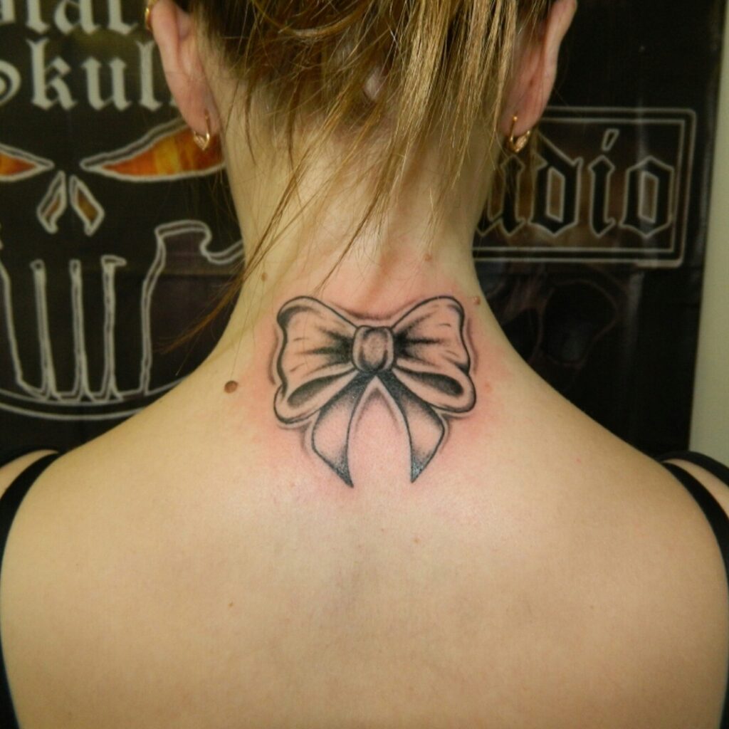 Bow tattoo on the back of the head for women