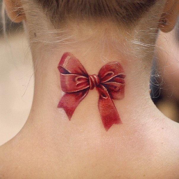 Bow tattoo on the back of the head for women