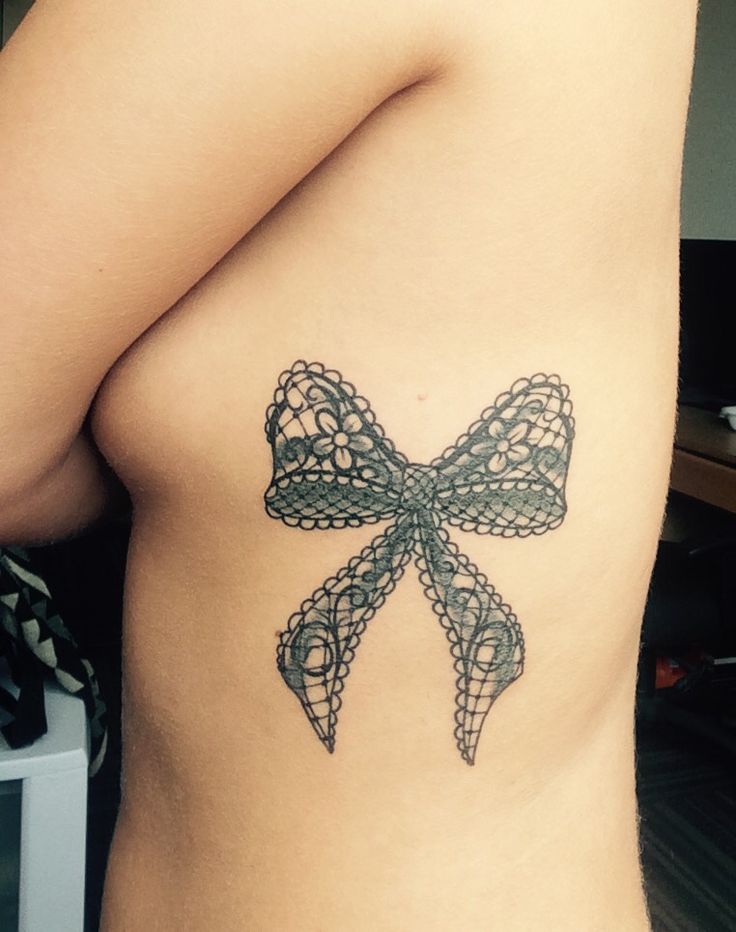 Bow tattoo on the side for women