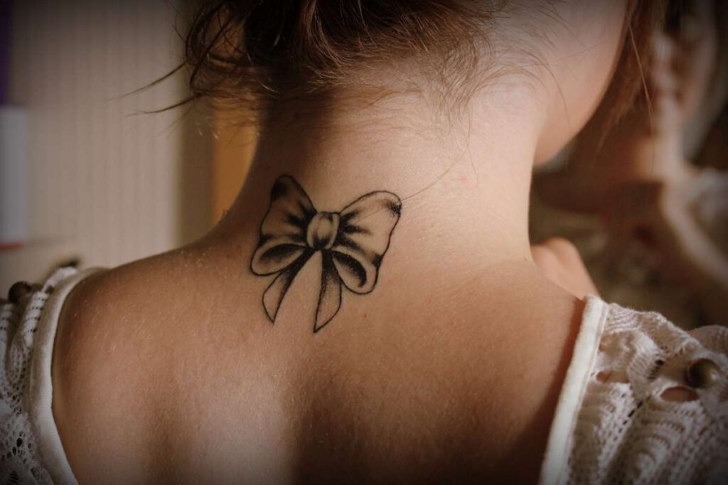 Bow tattoo on the back of the head for women