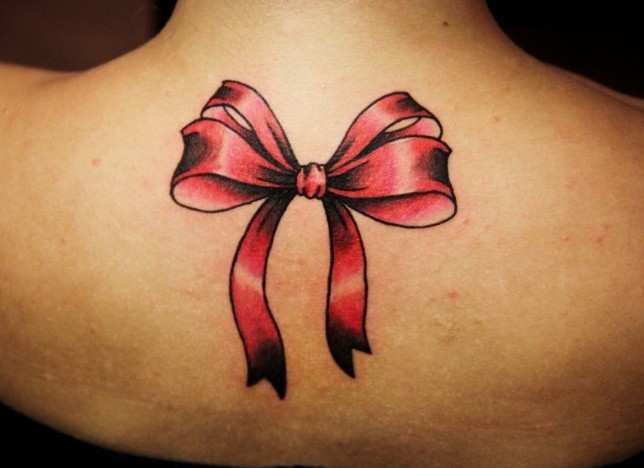 Bow tattoo on back for women