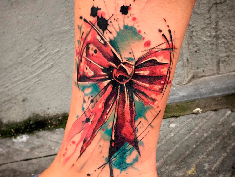 Colorful bow tattoo on shin for women