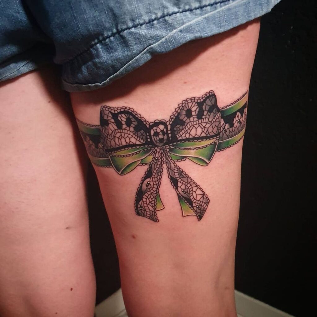 Bow tattoo on thigh for women