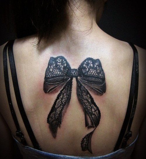 Bow tattoo on back for women