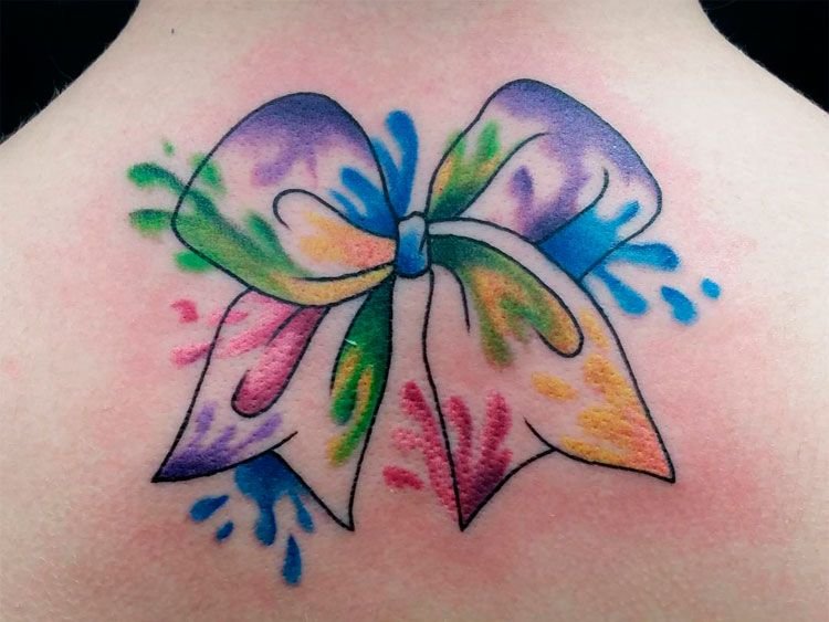 Bow tattoo on back for women