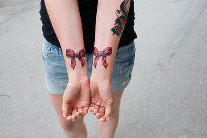 Bow tattoo on wrist for women