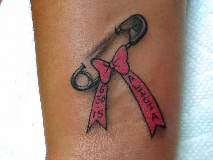 Bow tattoo on arm for women