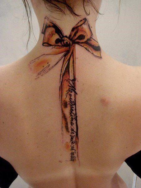 Bow tattoo on back for women