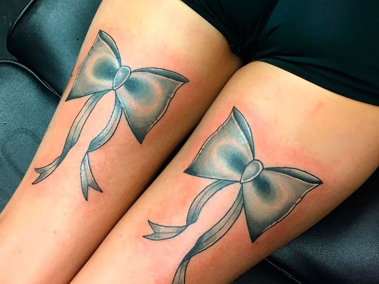 Bow tattoo on thigh for women