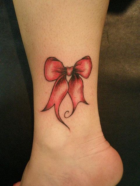 Bow tattoo on the shin for women