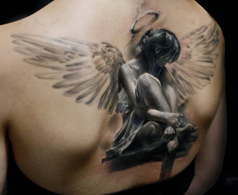 Angel tattoo on back for women