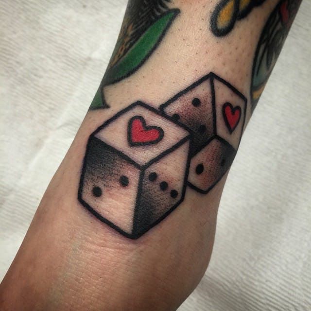 Color dice tattoo on arm for women