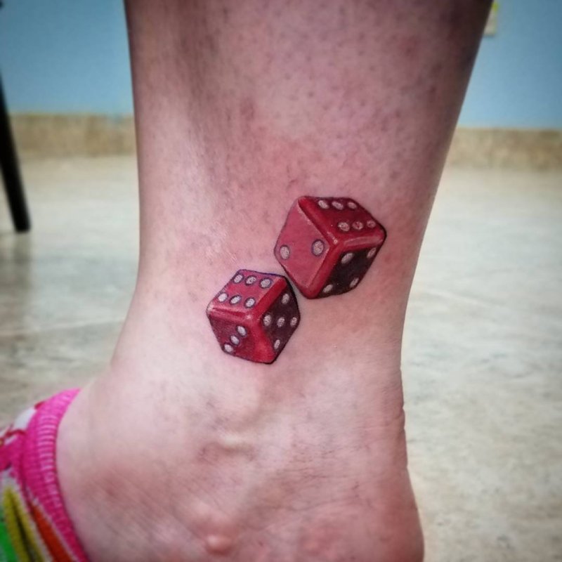 Dice tattoo on shin for women