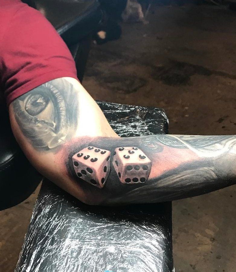 Dice tattoo on the arm for men