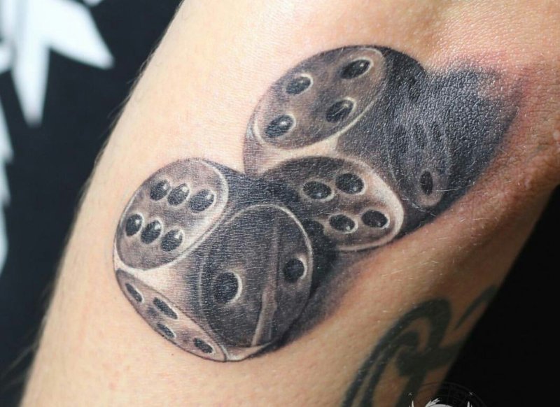 Dice tattoo on the arm for men