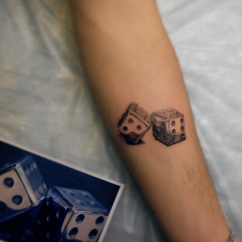 Dice tattoo on arm for women