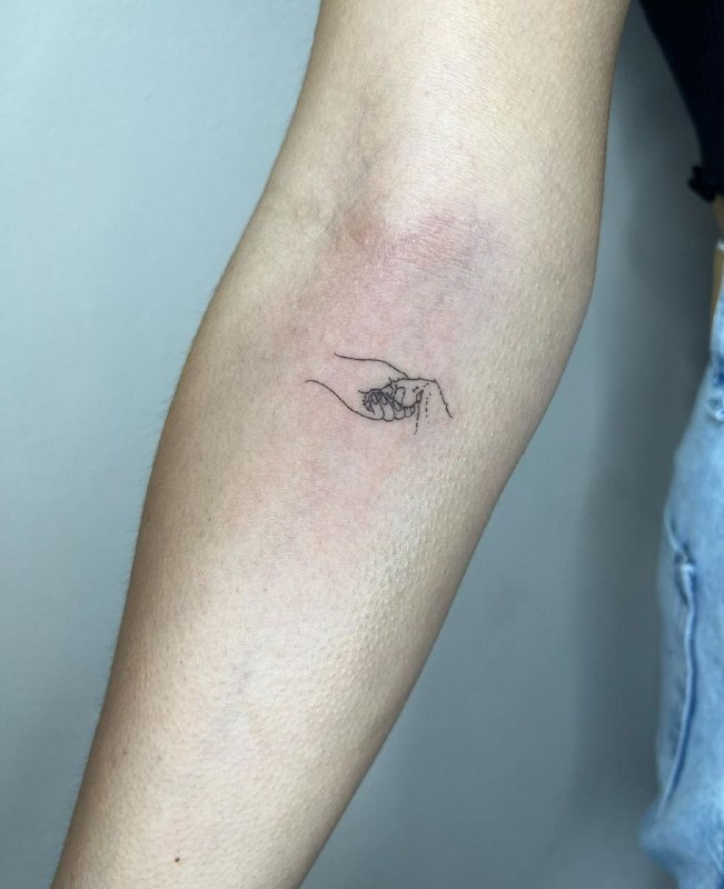 Minimalist style tattoo on the forearm for women