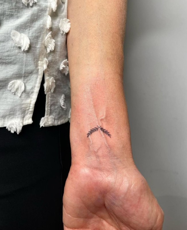 Minimalist tattoo on the wrist for men