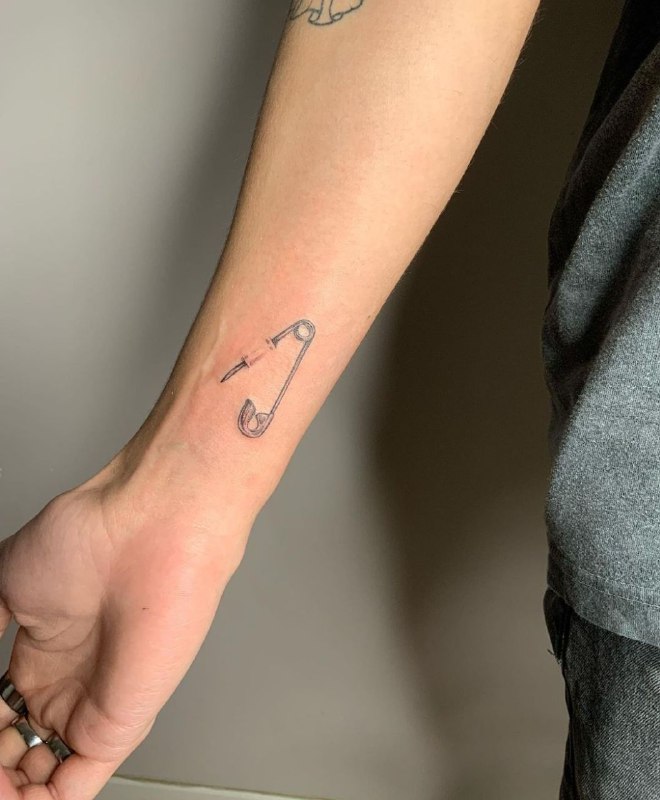 Minimalist style tattoo on the forearm for women