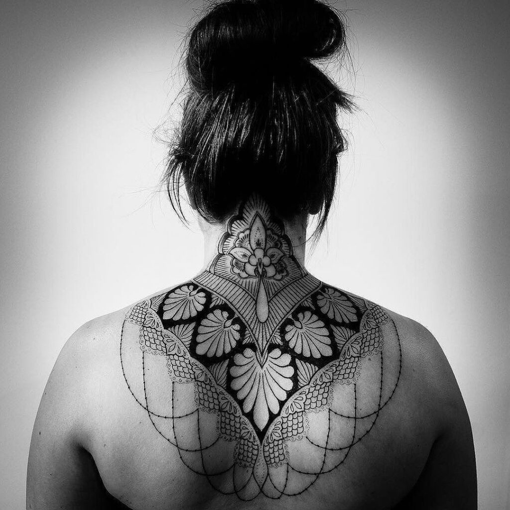 Ornamental style tattoo on the back for women