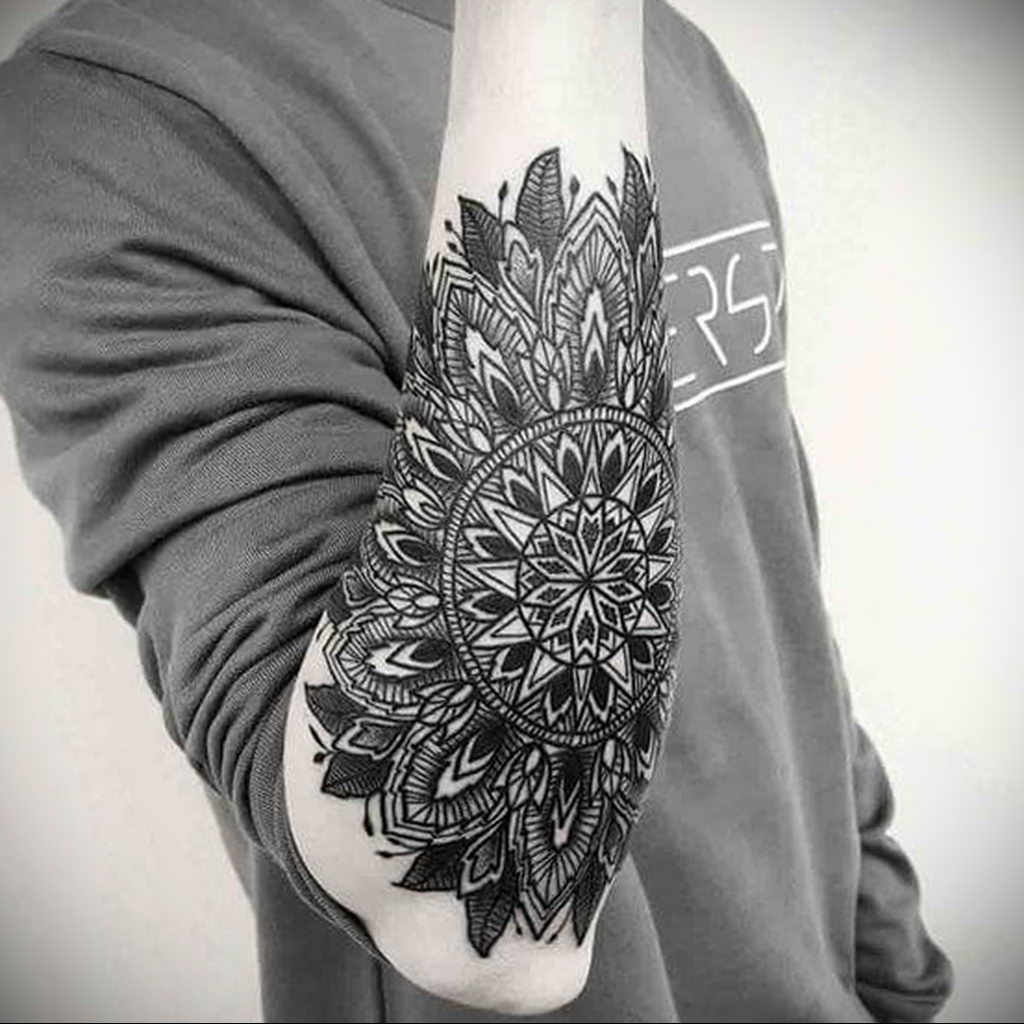 Ornamental style tattoo on the forearm for men