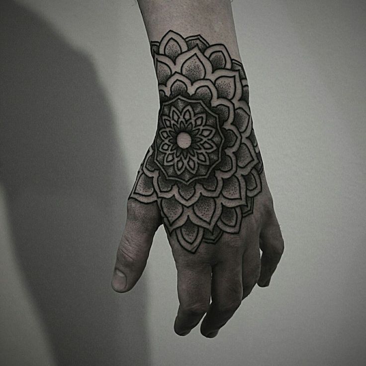 Ornamental style tattoo on the hand for men