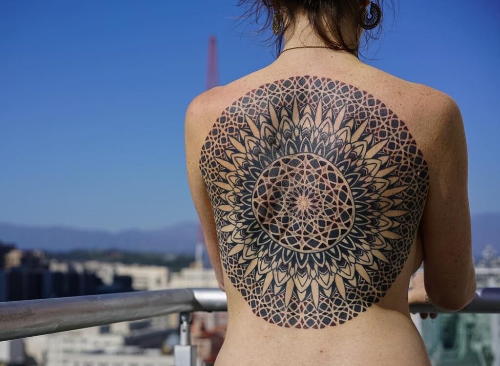 Ornamental style tattoo on the back for women