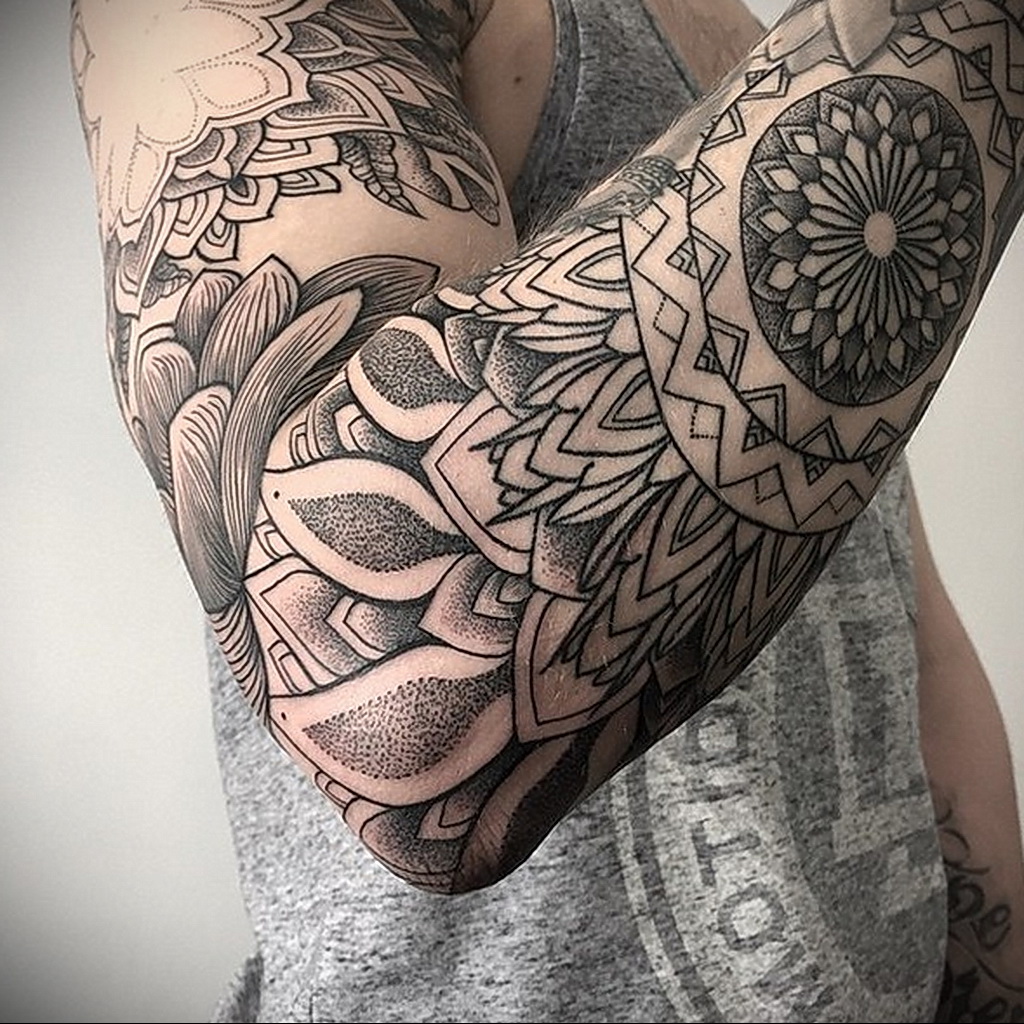 Ornamental style tattoo on the arm for men