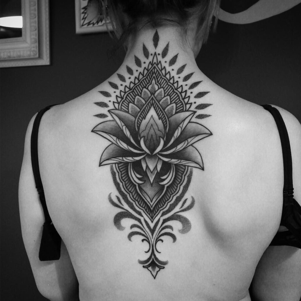 Ornamental style tattoo on the back for women