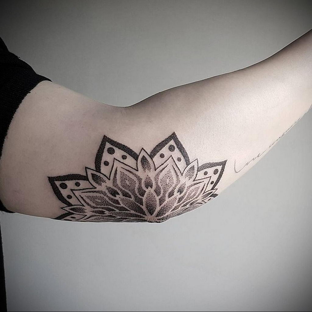 Ornamental style tattoo on the elbow for men