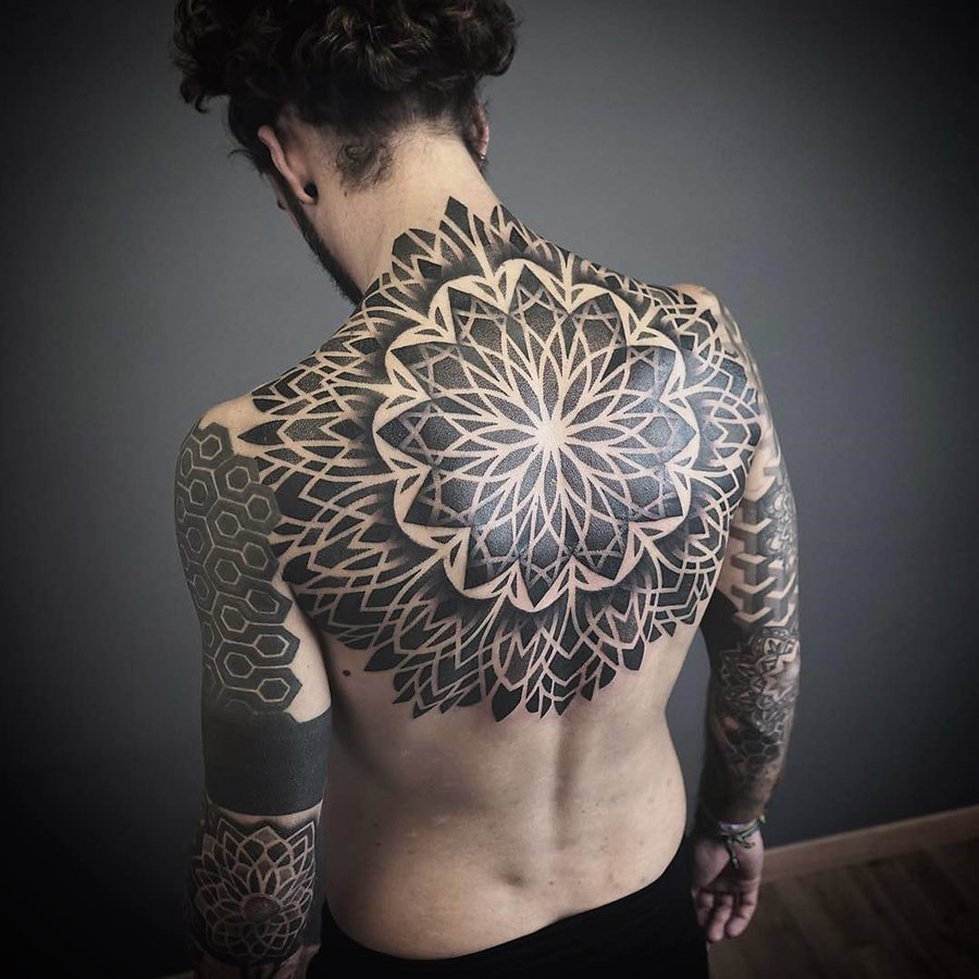 Ornamental style tattoo on the back for men