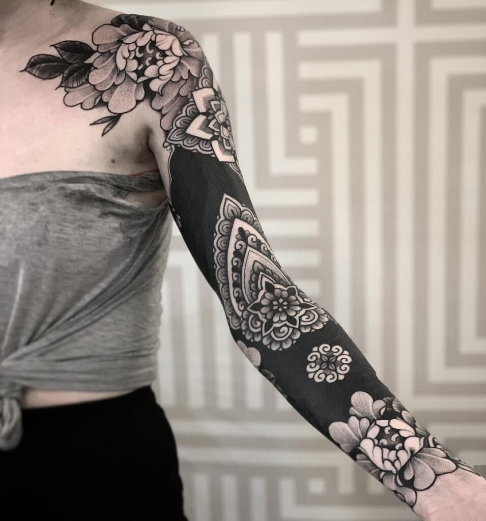 Ornamental style tattoo on the arm for women