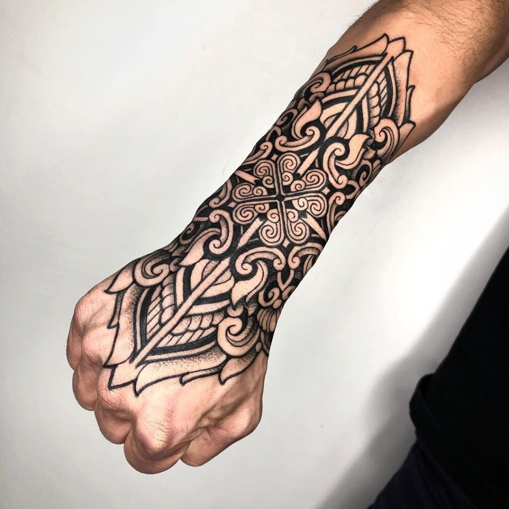 Ornamental style tattoo on the arm for men