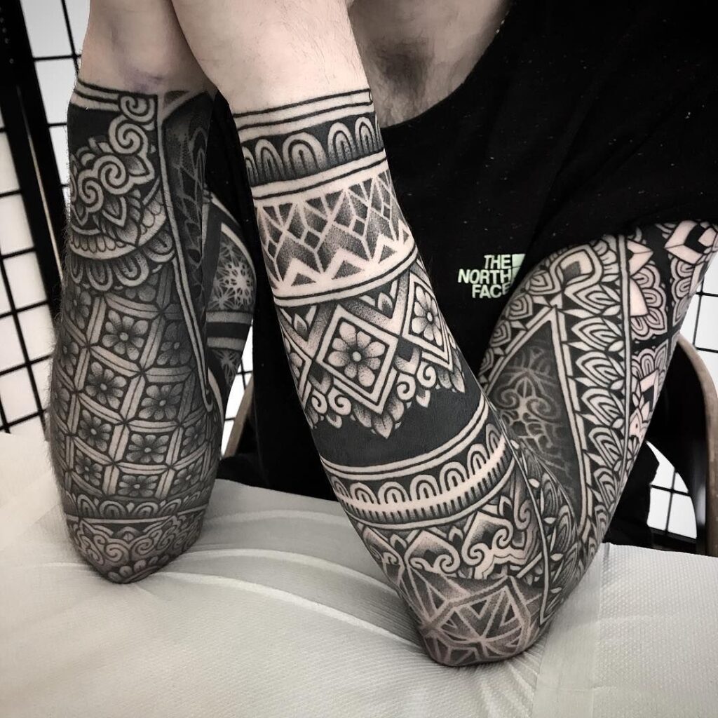 Ornamental style tattoo on the arm for men