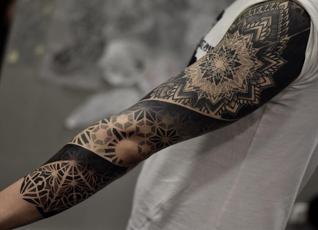 Ornamental style tattoo on the arm for men