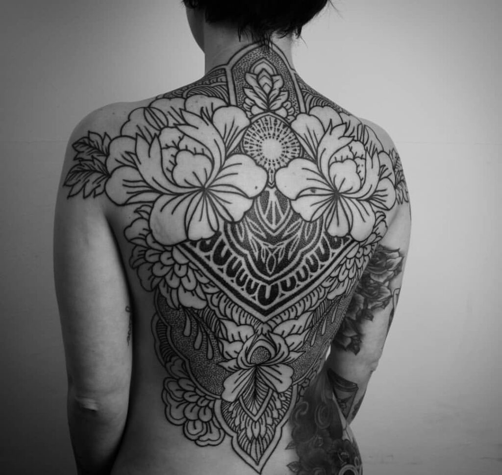 Ornamental style tattoo on the back for women