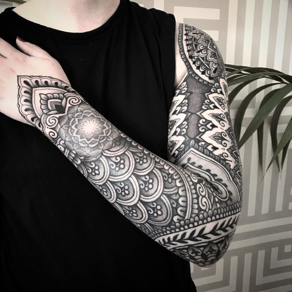 Ornamental style tattoo on the arm for men