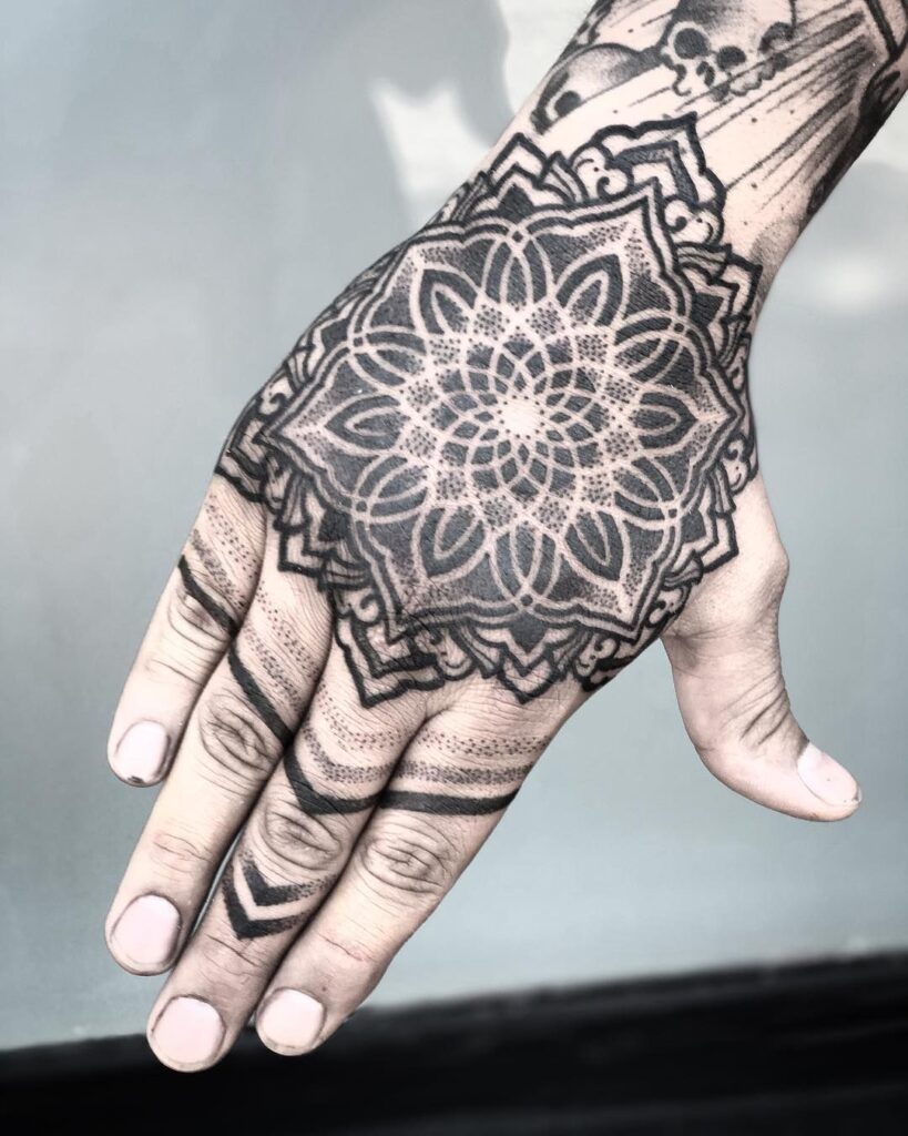 Ornamental style tattoo on the hand for men