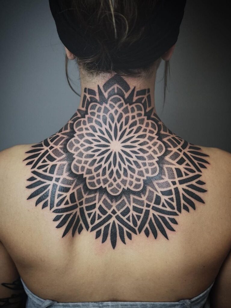 Ornamental style tattoo on the back for women