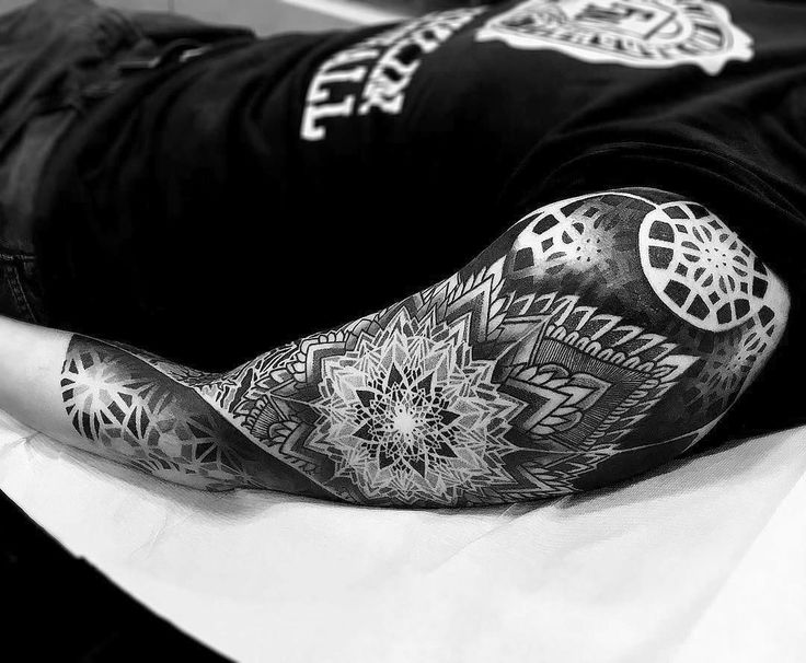 Ornamental style tattoo on the arm for men