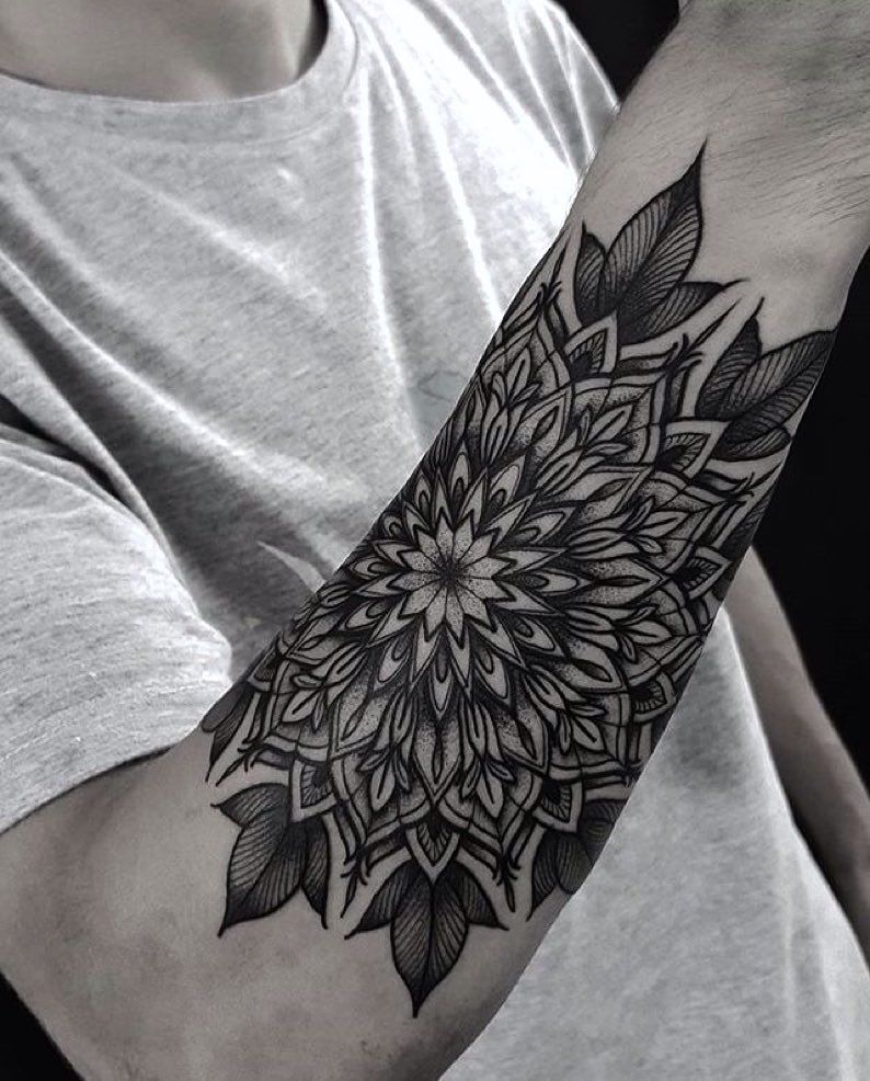 Ornamental style tattoo on the forearm for men