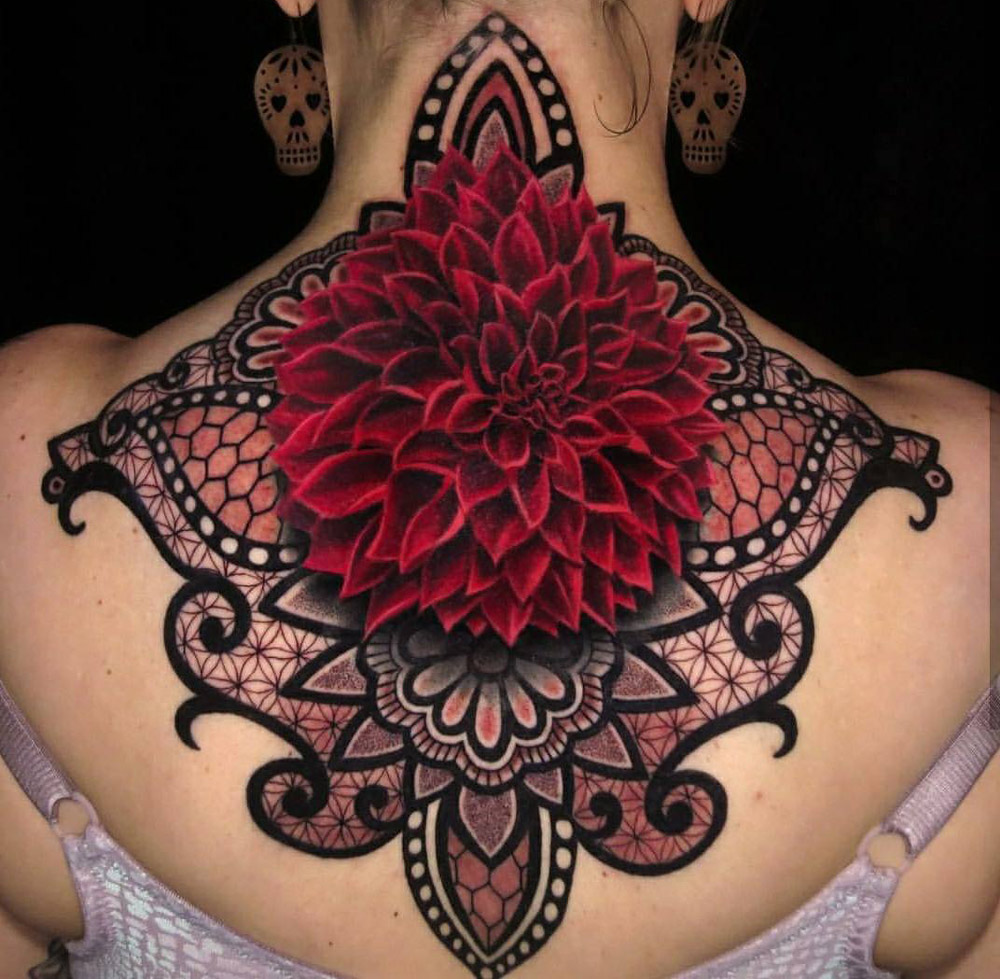 Colorful ornamental tattoo on the back for women