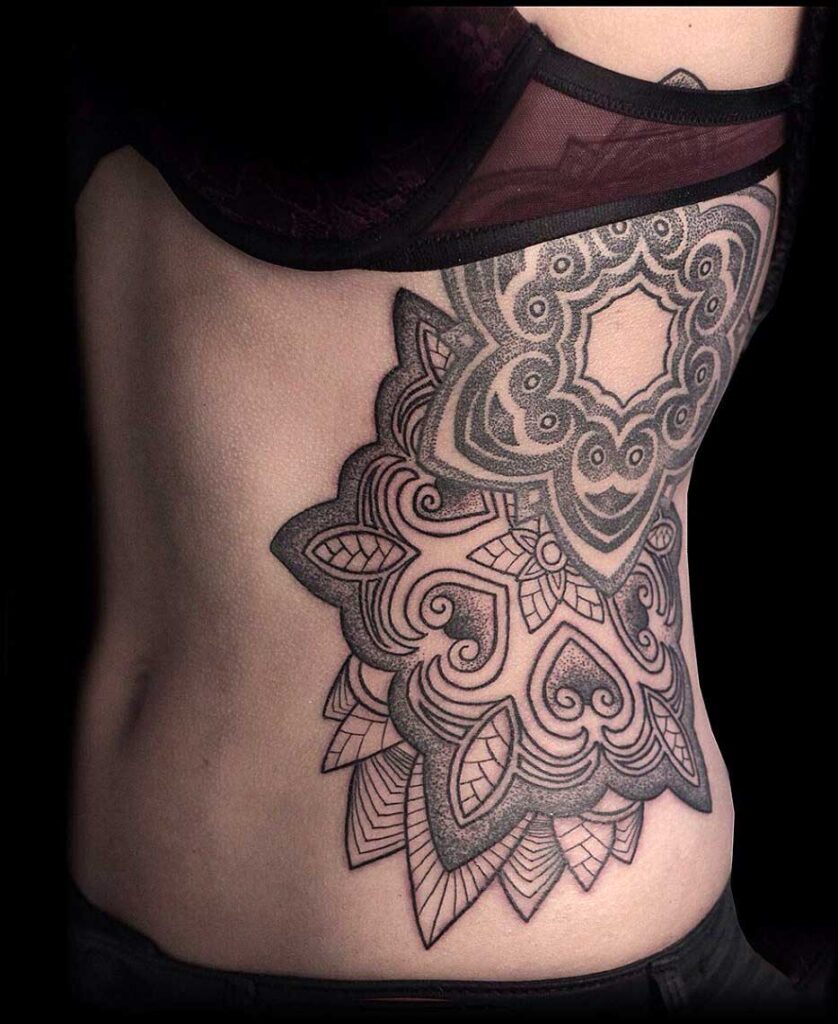 Ornamental style tattoo on the side for women