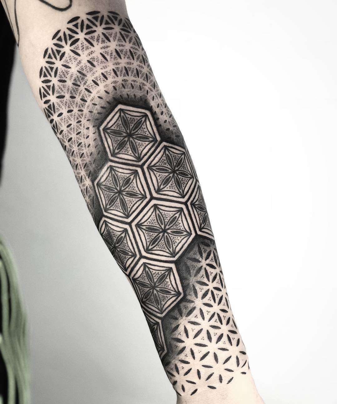 Ornamental style tattoo on the forearm for men