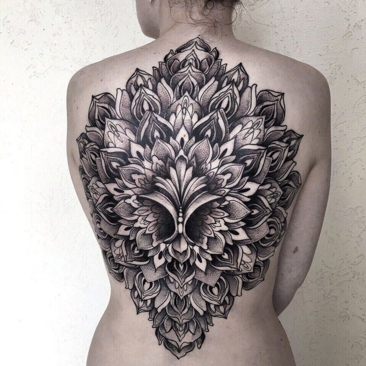 Ornamental style tattoo on the back for women