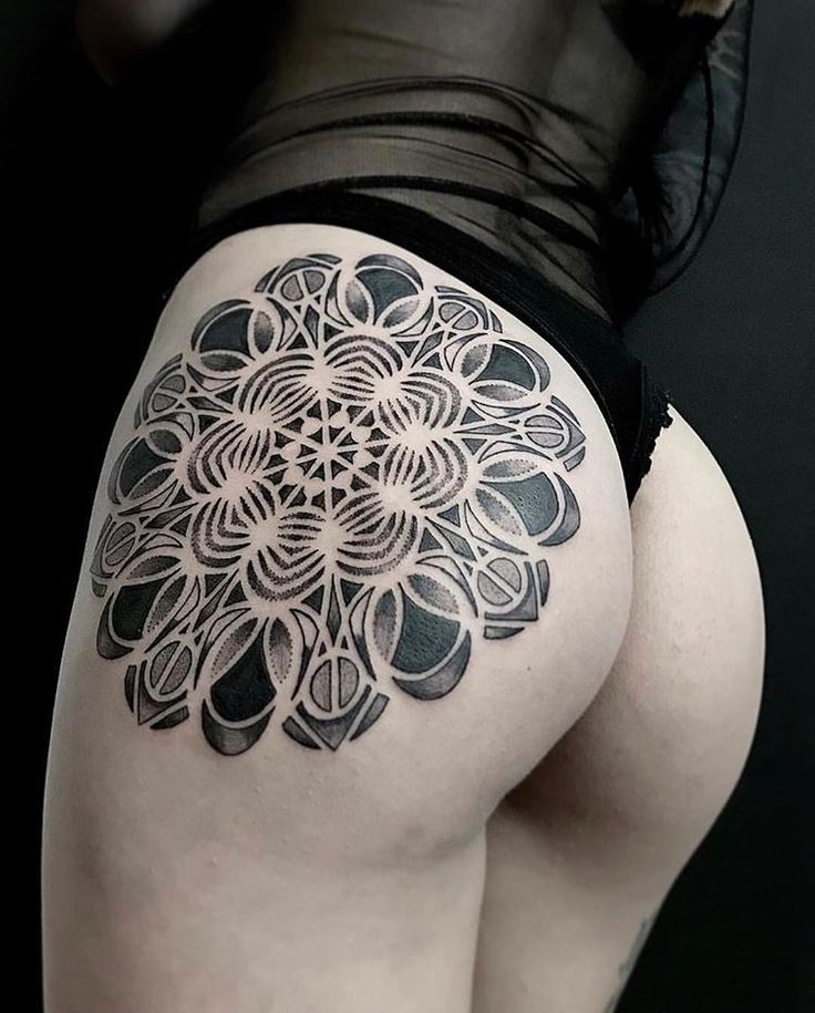 Ornamental style tattoo on the hip for women