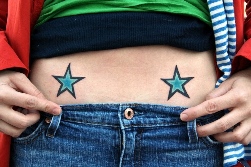 Star tattoo on stomach for women